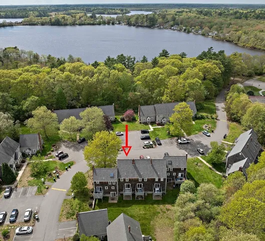 an aerial view of a house with a lake view