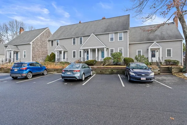a car parked in front of a white house
