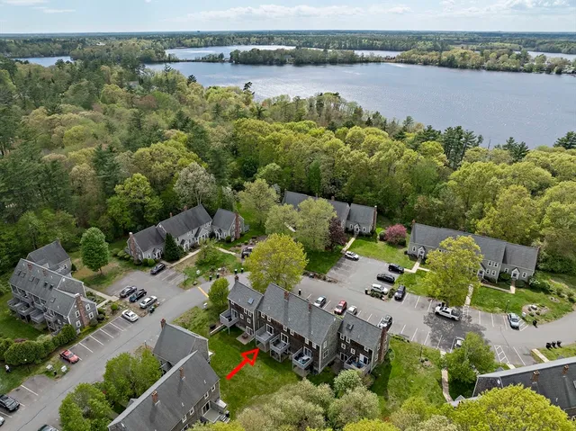 an aerial view of a house with a lake view