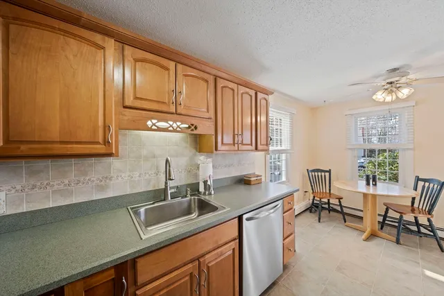 a kitchen with stainless steel appliances granite countertop a sink and cabinets