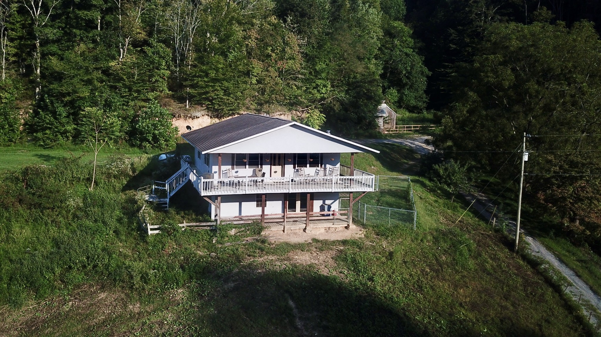 2528 Adamson Branch Road Liberty, TN 37095 - Photo 2 of 22 a view of a wooden house next to a yard with green space