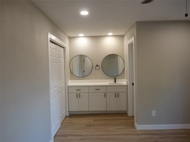 a view of a bathroom with mirror and sink