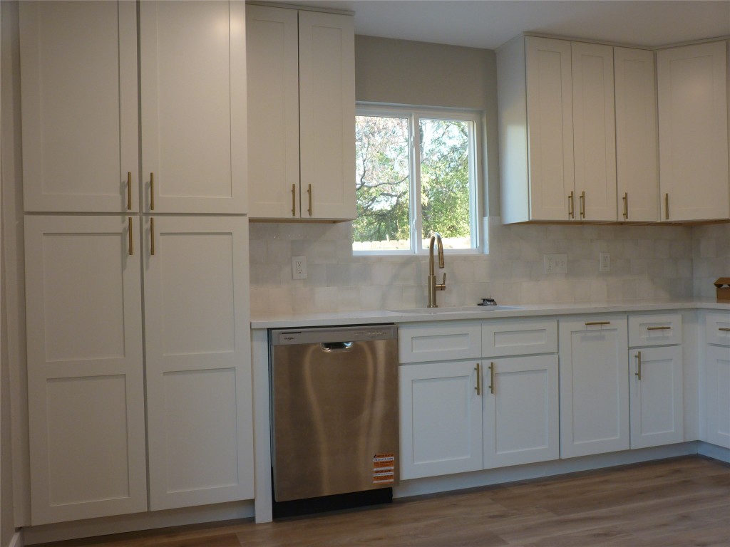 Undisclosed Address Austin, TX 78745 - Photo 7 of 20 a kitchen with white cabinets and a window