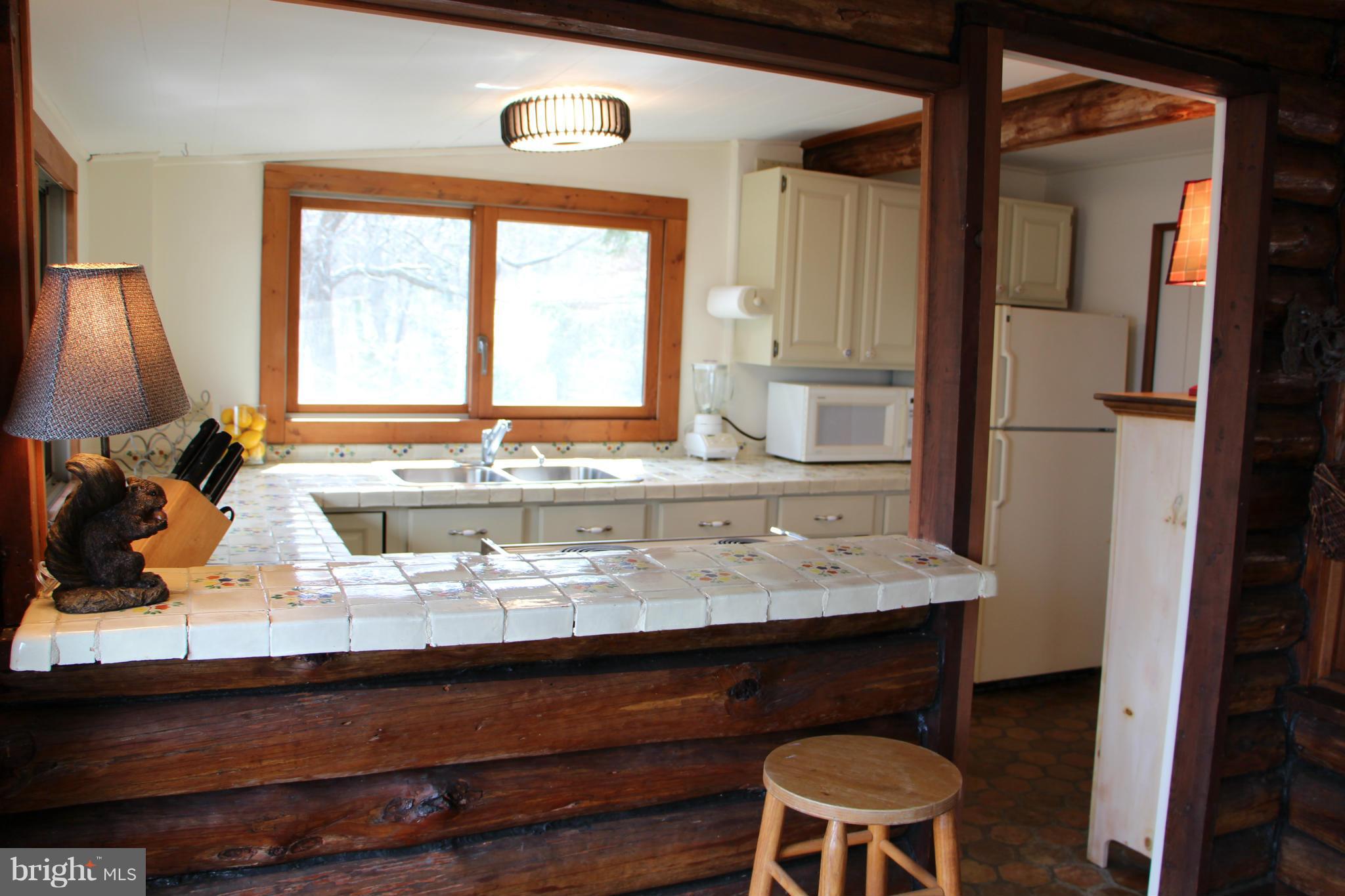 2168 Cedar Road Port Republic, MD 20676 - Photo 16 of 30 Kitchen bar opens to family room