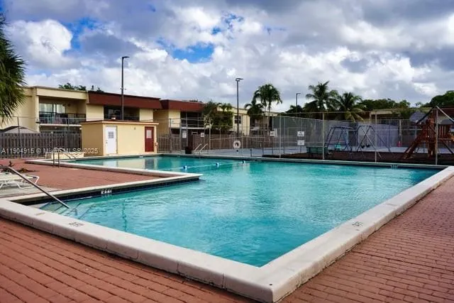 a view of a swimming pool with a yard