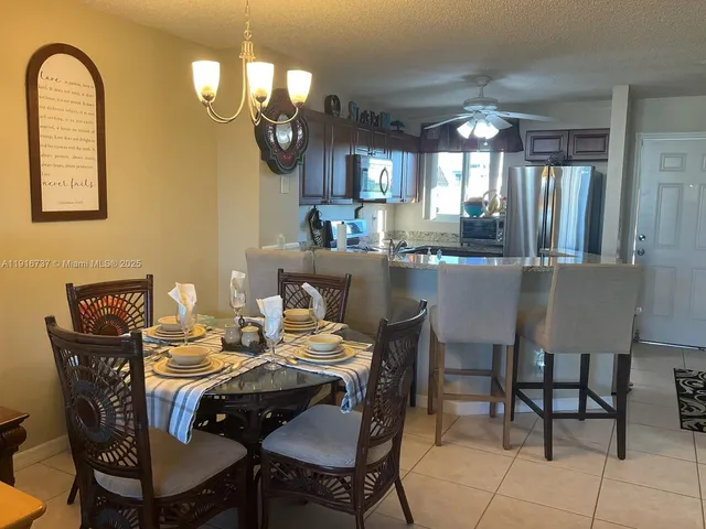 a dining room with furniture and chandelier