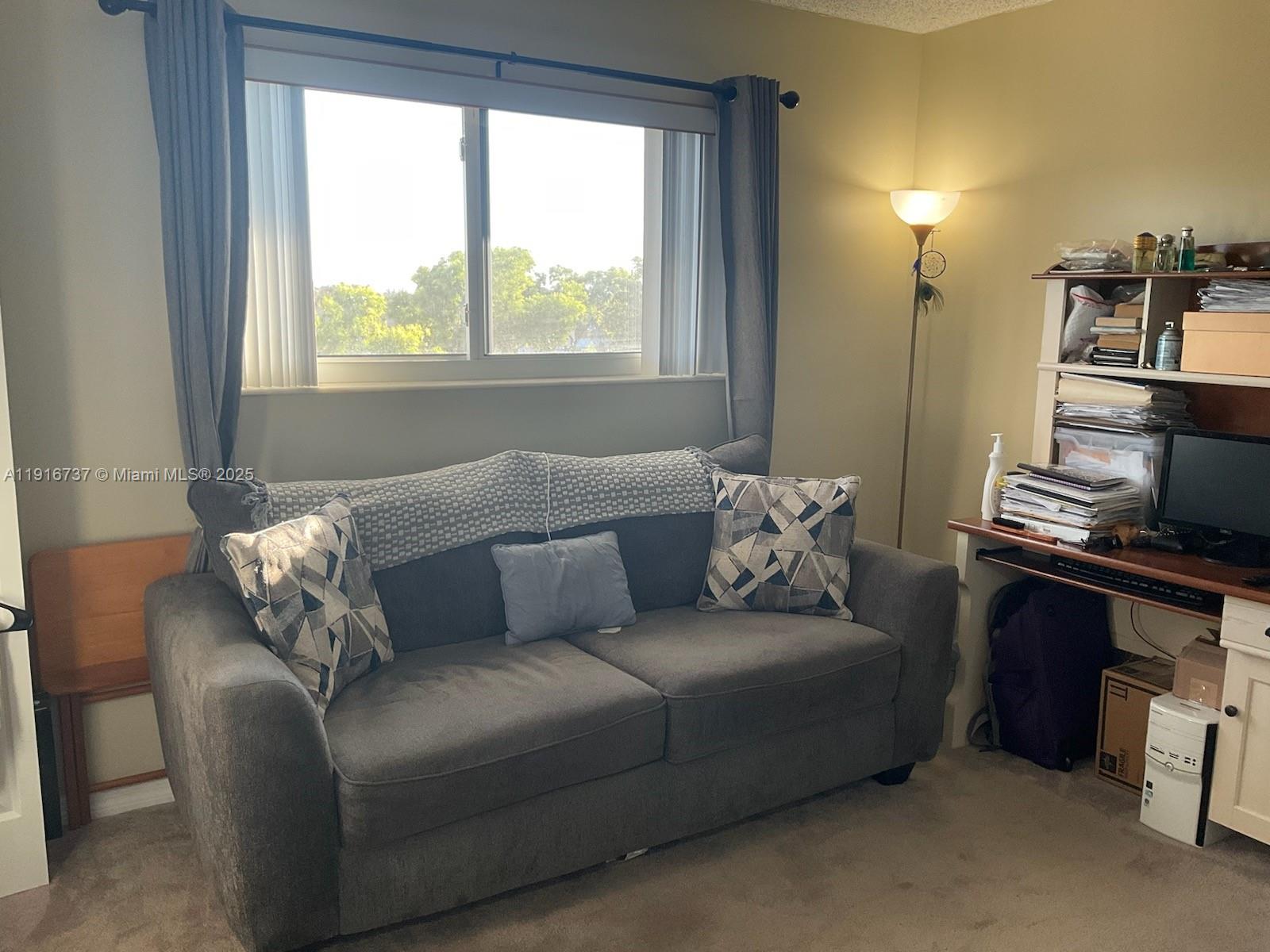 8730 Sherman Circle North, Unit 407 Miramar, FL 33025 - Photo 8 of 11 a living room with furniture and a window