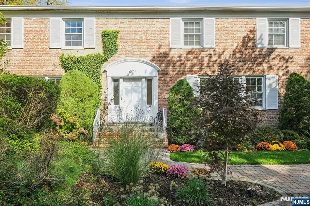 a view of a trees in front of a brick house