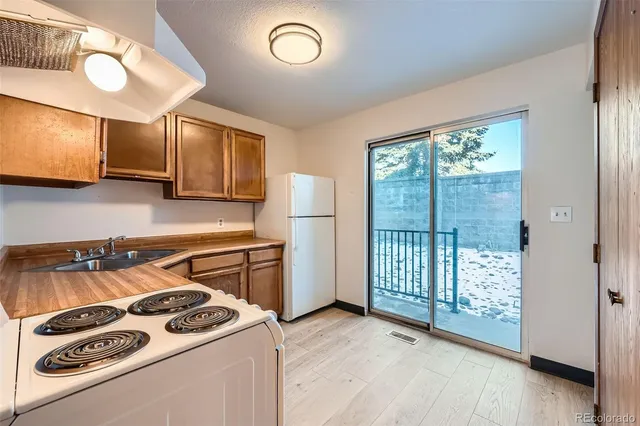 a kitchen with a stove and a refrigerator