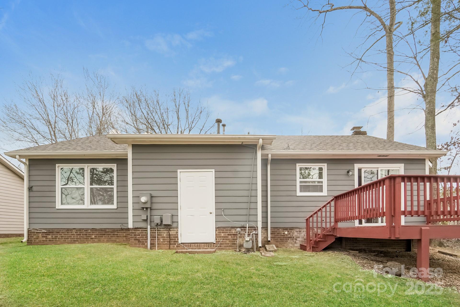 8301 Rocester Drive Charlotte, NC 28215 - Photo 15 of 16 a view of a house with a backyard