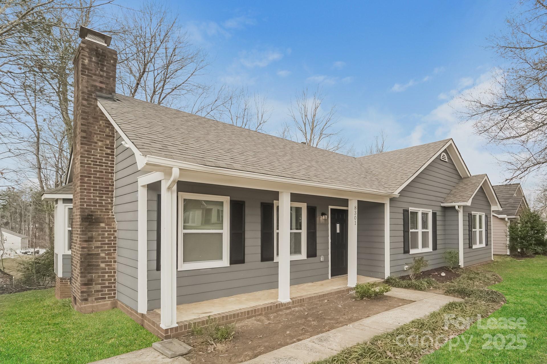 8301 Rocester Drive Charlotte, NC 28215 - Photo 2 of 16 front view of a house with a yard