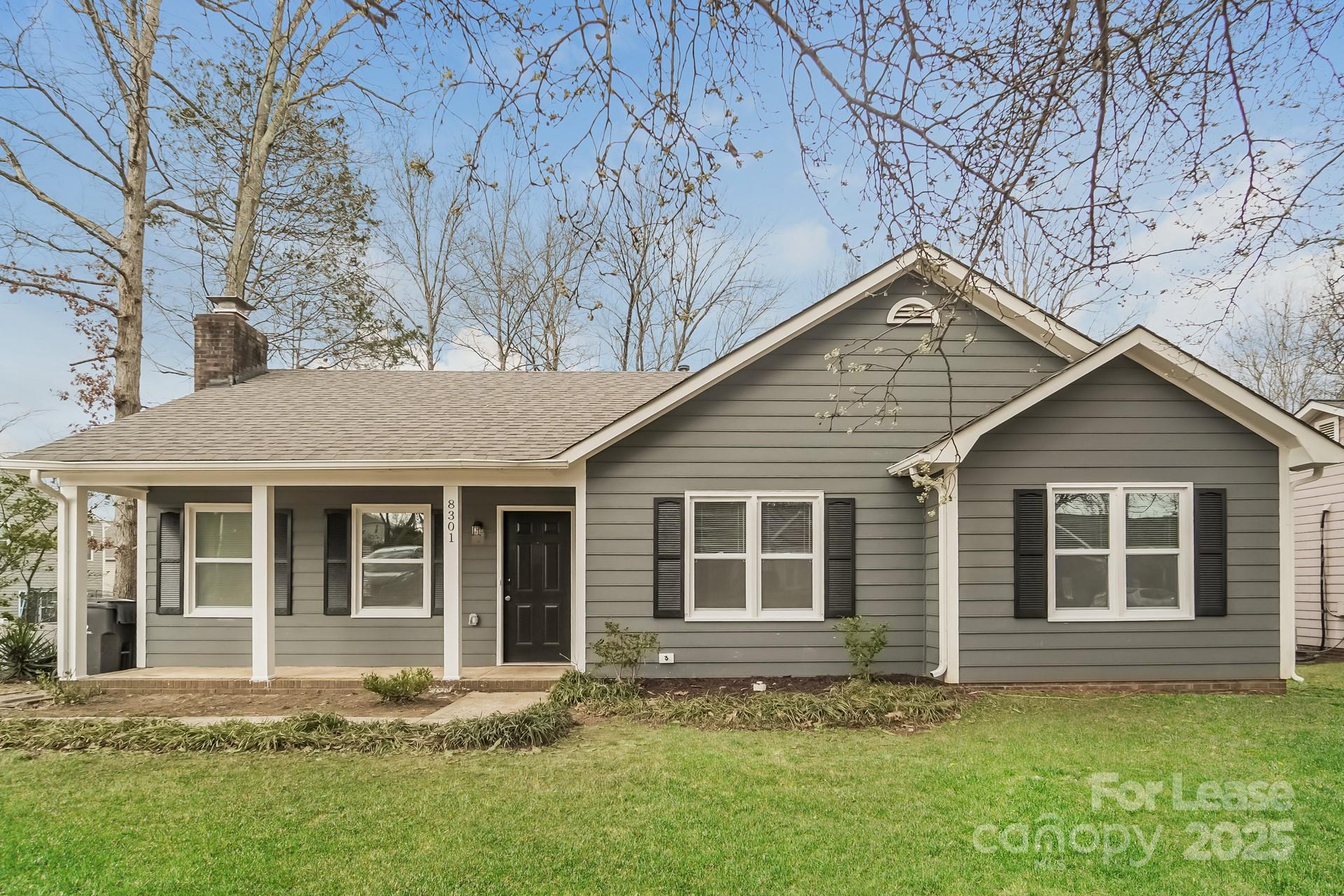 8301 Rocester Drive Charlotte, NC 28215 - Photo 3 of 16 a house with a yard