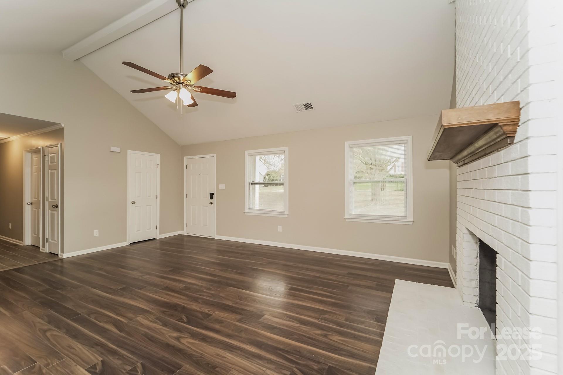 8301 Rocester Drive Charlotte, NC 28215 - Photo 5 of 16 a view of empty room with wooden floor and fan
