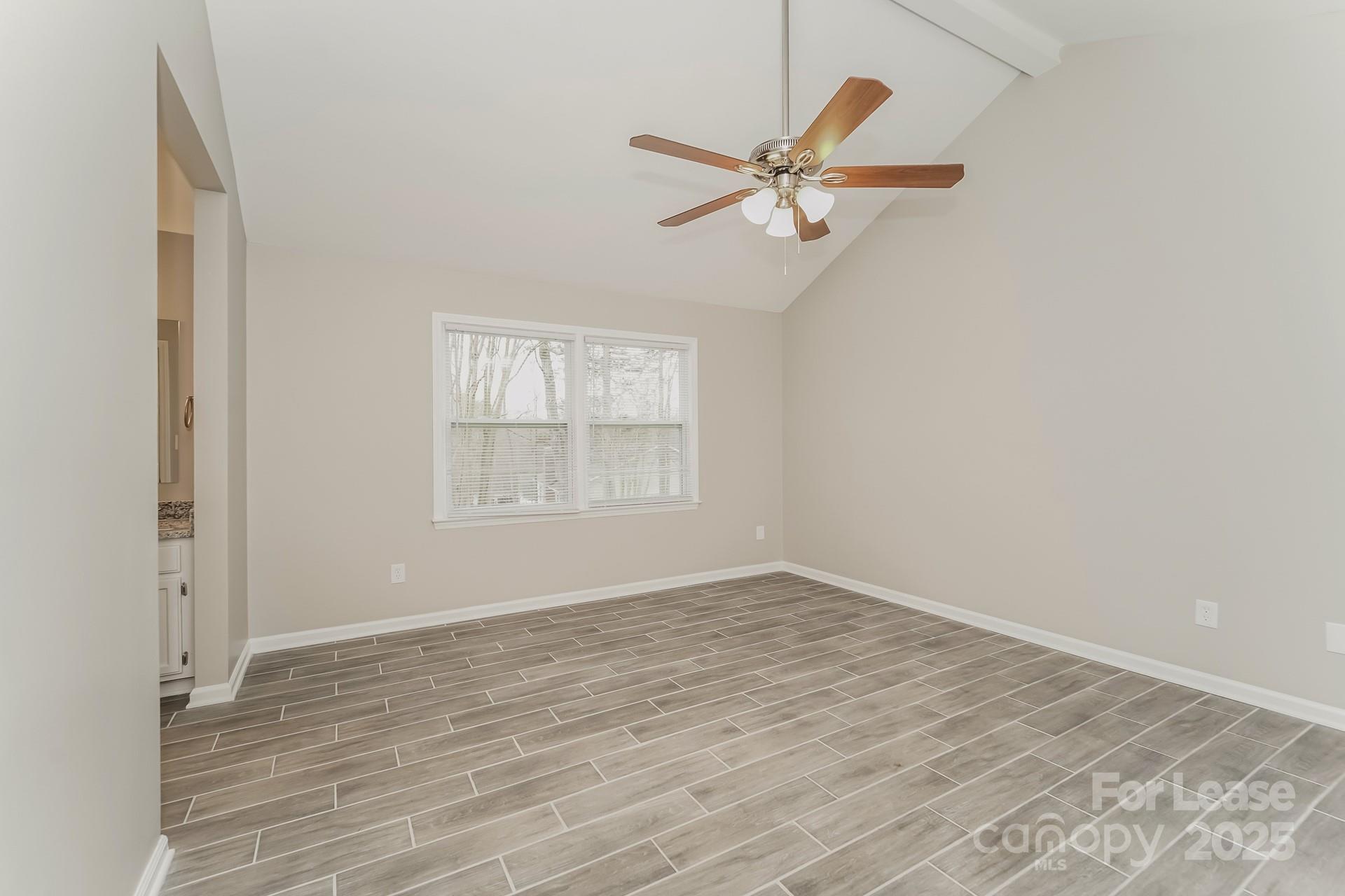 8301 Rocester Drive Charlotte, NC 28215 - Photo 10 of 16 a view of empty room with wooden floor and fan