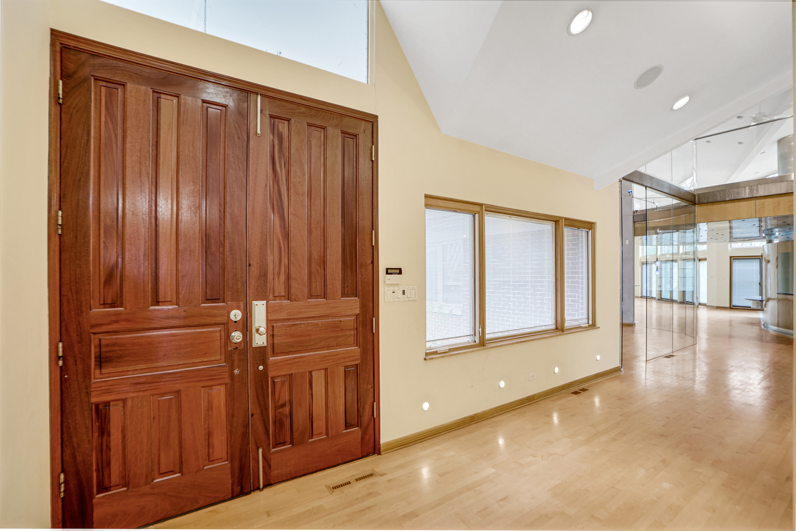 109 Sunset Ridge Road Northfield, IL 60093 - Photo 3 of 30 a view of a hallway with wooden floor and windows