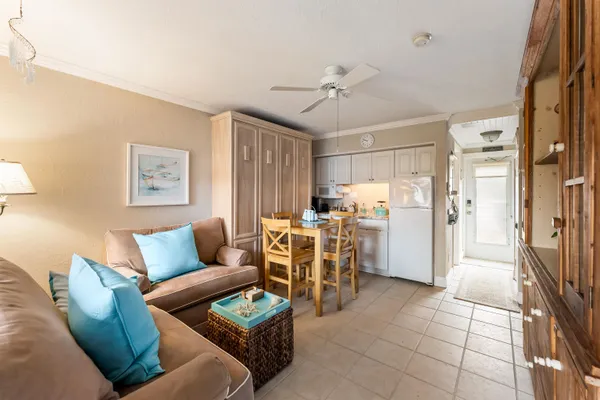 a living room with furniture and a view of kitchen