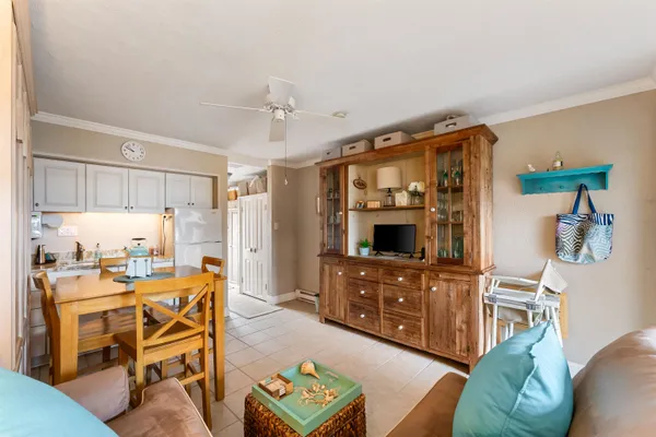 a view of a dining room with furniture and a kitchen
