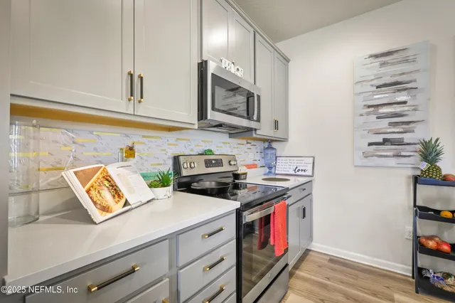 a kitchen with stainless steel appliances granite countertop a stove and a sink