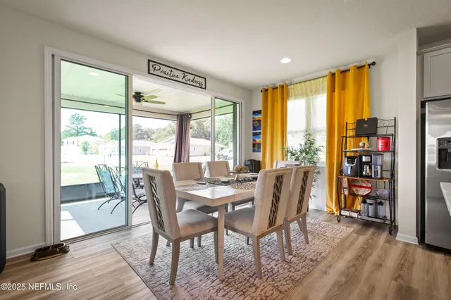 a view of a dining room with furniture and a potted plant