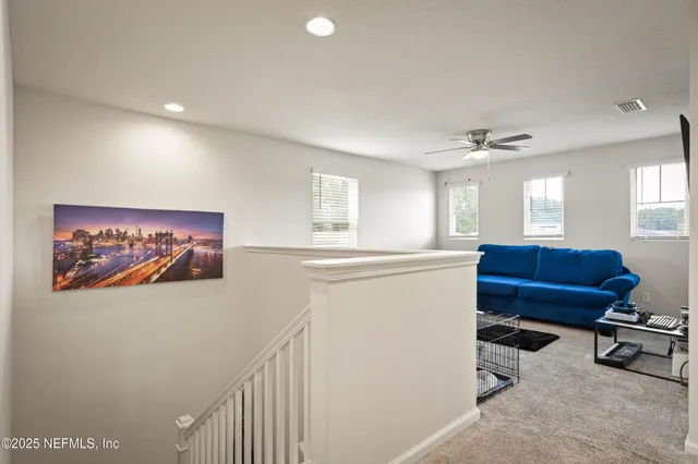 a view of a hallway with workspace and a window