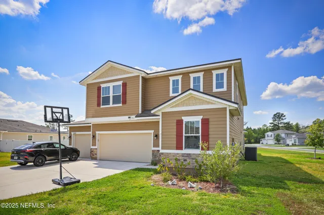 a front view of a house with a yard and garage