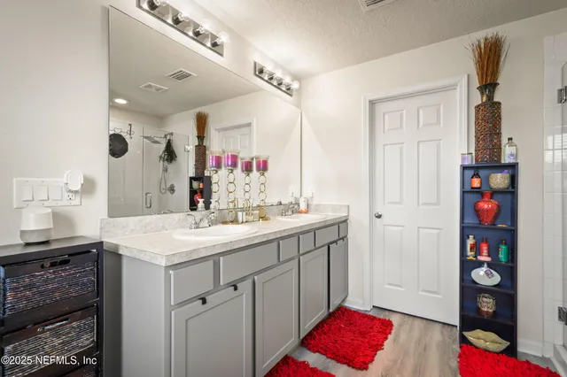 a bathroom with a sink vanity and a mirror