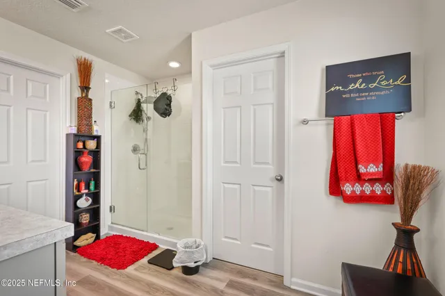 a very nice looking room with a red couch and a chandelier