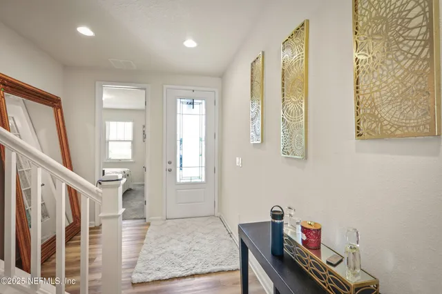 a view of an entryway with wooden floor