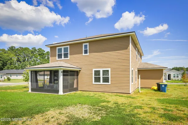 a view of green field with house in the background