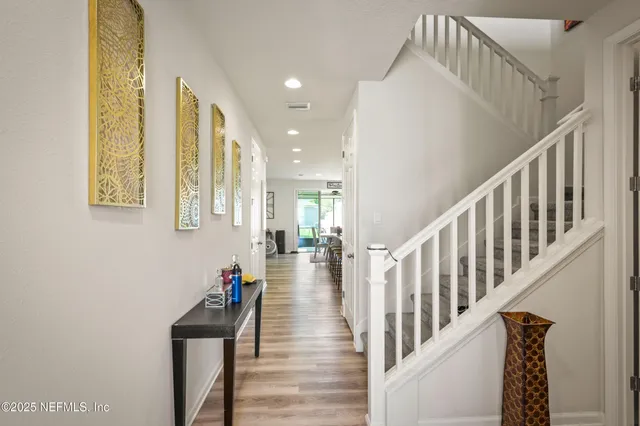 a view of entryway and hall with wooden floor