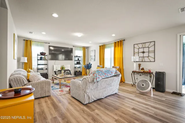 a living room with furniture and a flat screen tv