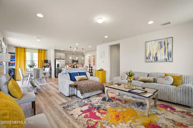 a living room with furniture fireplace and a table
