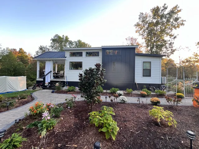 a view of a house with yard and sitting area