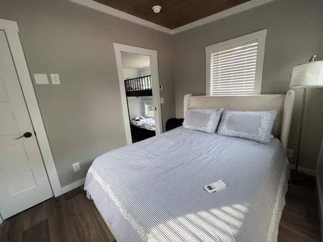 a large bed sitting in a bedroom next to a window and dresser
