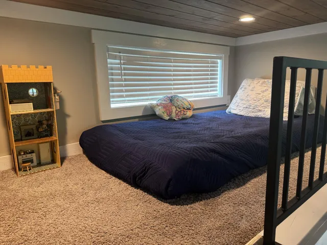 a view of entryway bedroom and hall with wooden floor