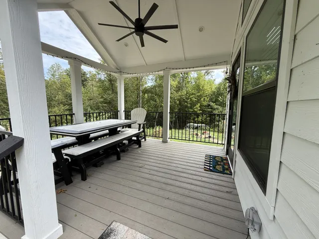 a kitchen that has a sink and a stove top oven with wooden floor
