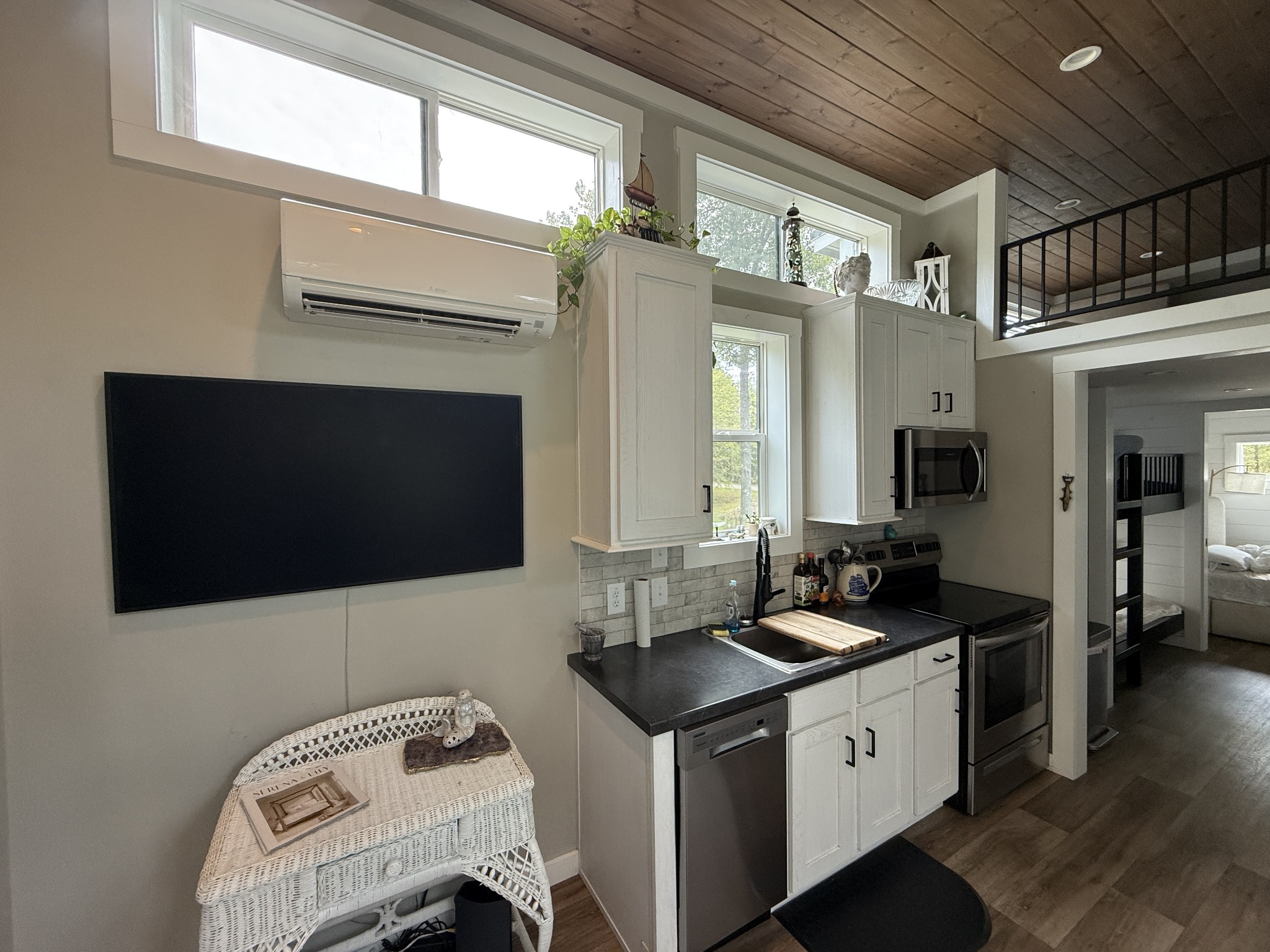 1530 Prince Road Big Sandy, TN 38221 - Photo 24 of 31 a kitchen that has a sink and a stove top oven with wooden floor
