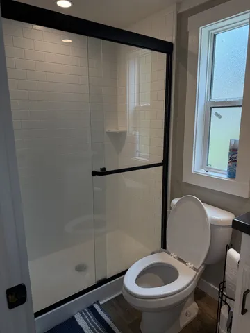 a bathroom with a toilet sink and mirror