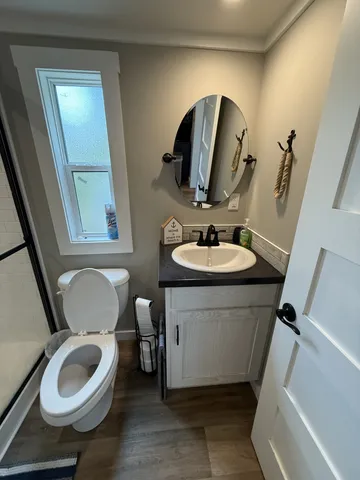 a bathroom with a granite countertop sink toilet and a shower