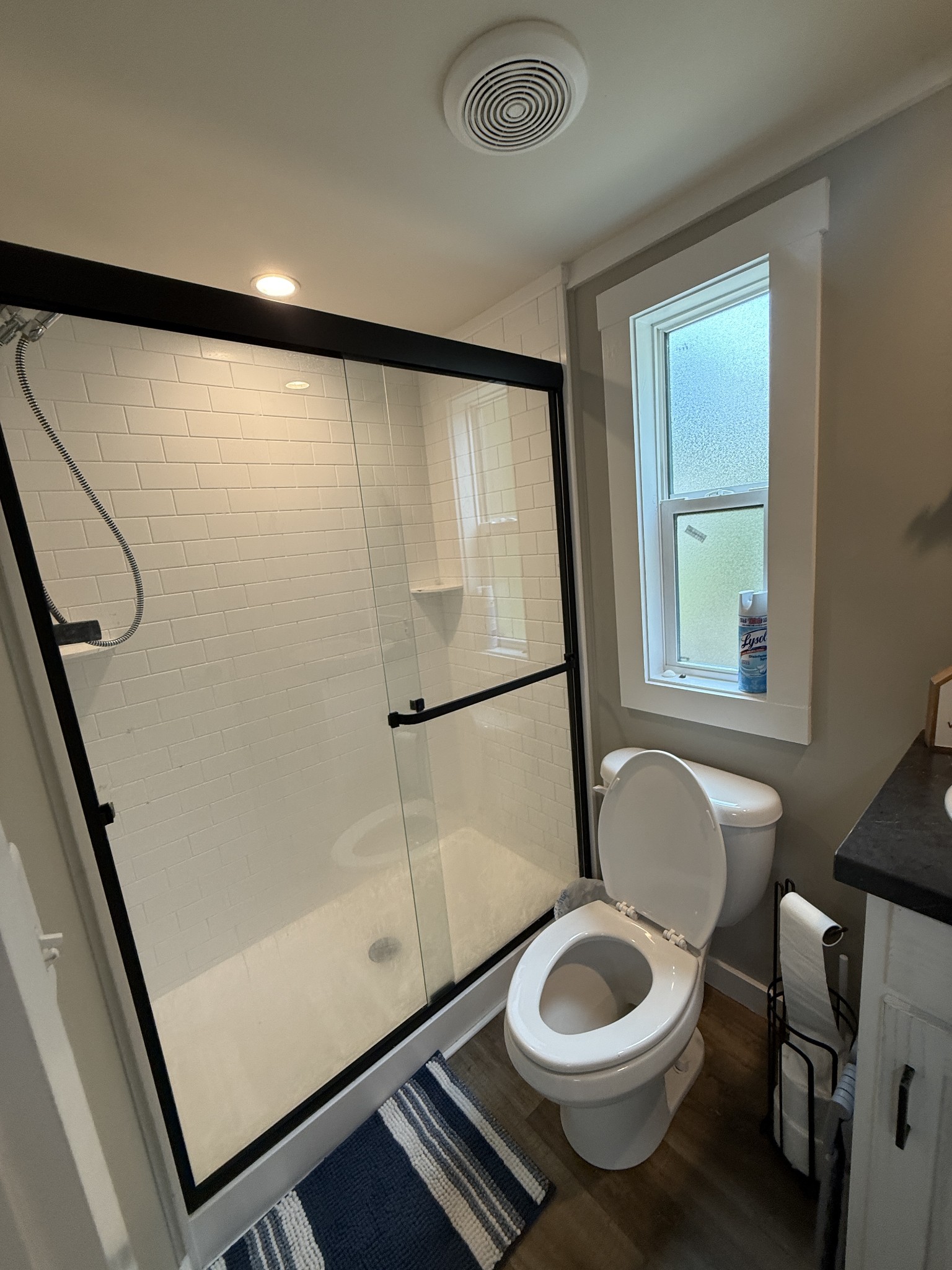 1530 Prince Road Big Sandy, TN 38221 - Photo 28 of 31 a bathroom with a granite countertop sink toilet and a shower