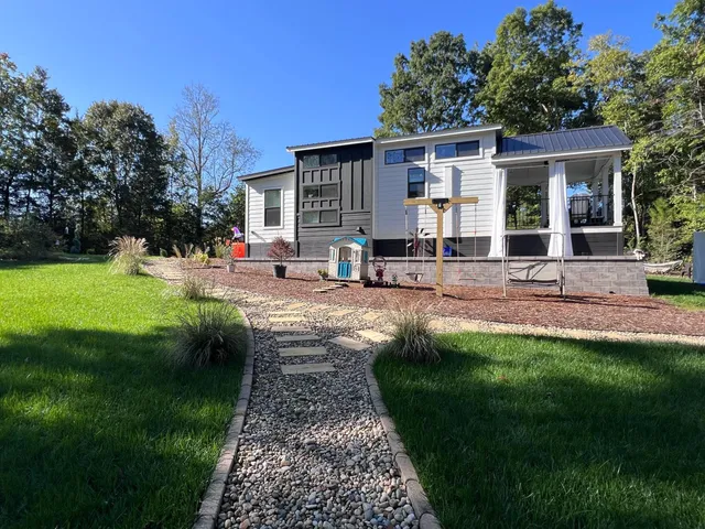 a view of a house with backyard sitting area and garden