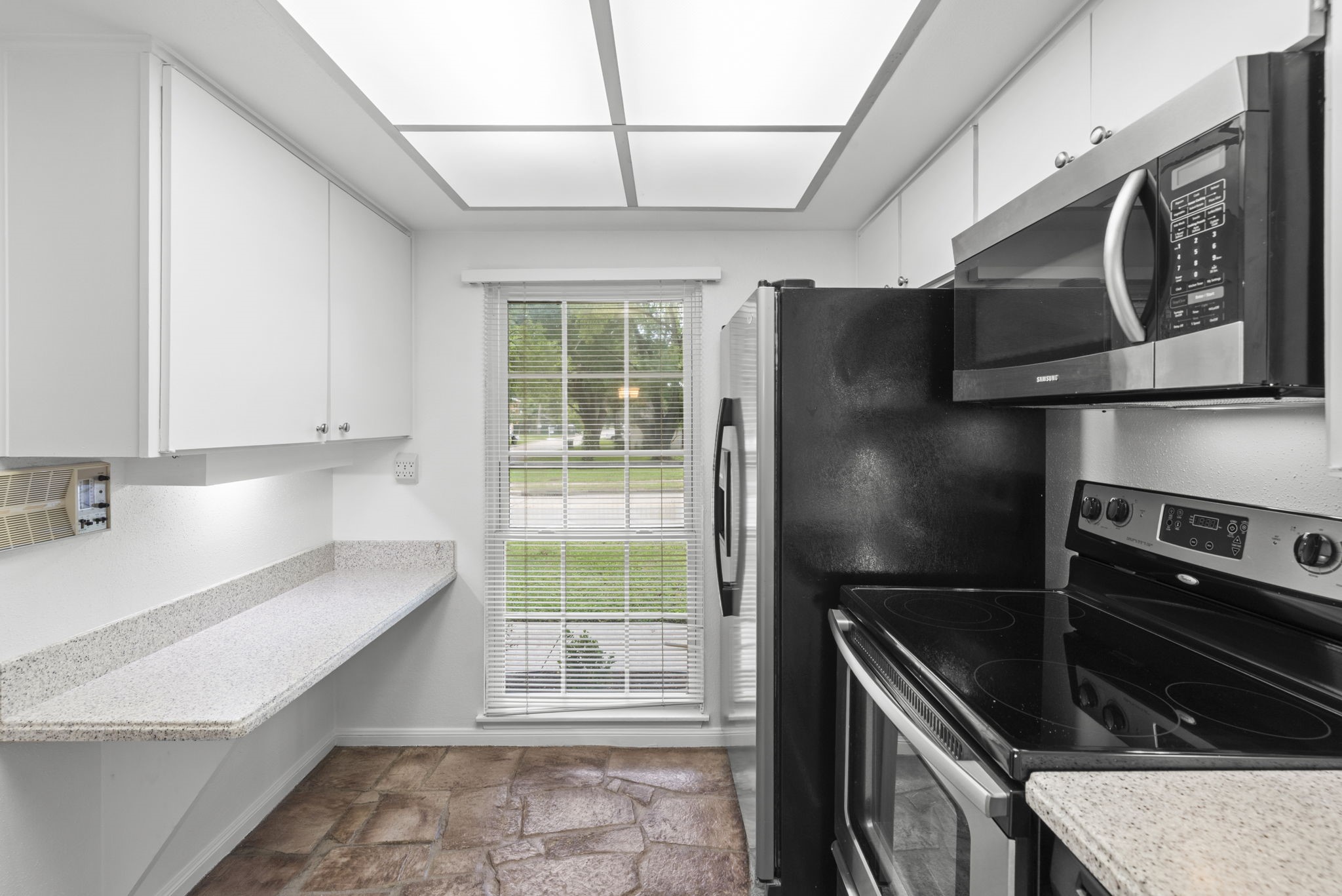 9668 Westview Drive, Unit 2 Houston, TX 77055 - Photo 11 of 34 a kitchen with a refrigerator and a sink