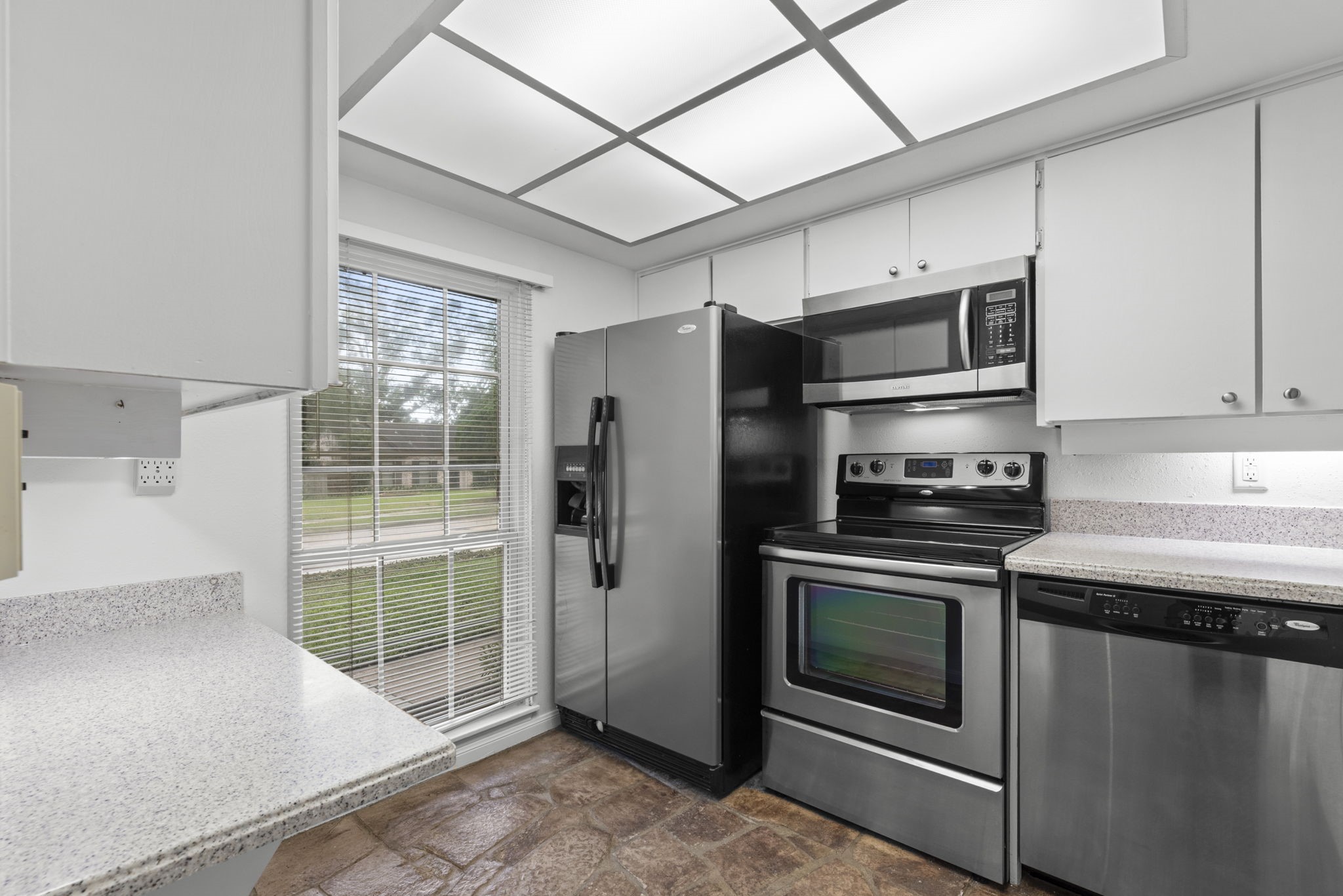 9668 Westview Drive, Unit 2 Houston, TX 77055 - Photo 12 of 34 a kitchen with granite countertop a stove and a refrigerator