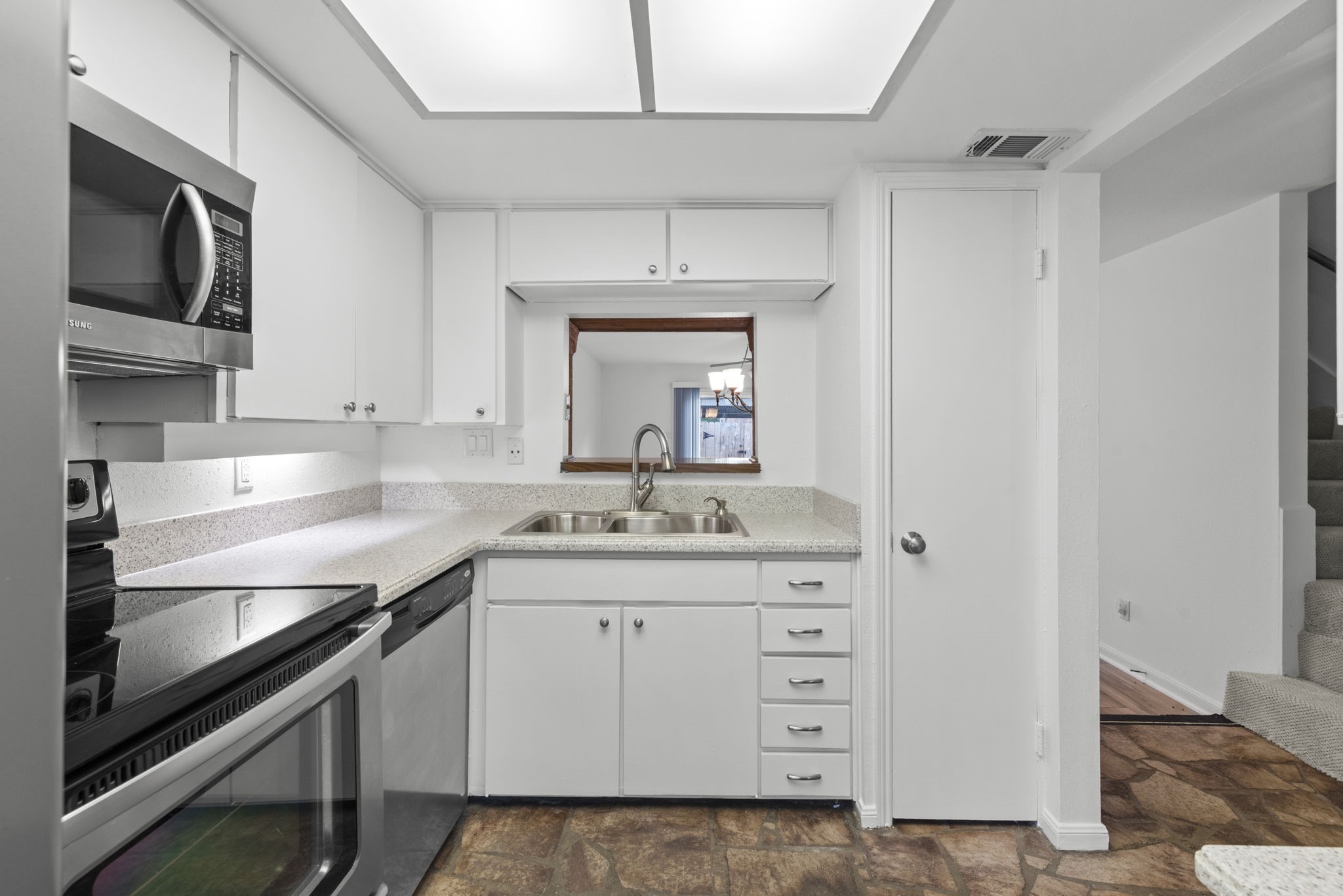 9668 Westview Drive, Unit 2 Houston, TX 77055 - Photo 13 of 34 a kitchen with a sink stove and microwave