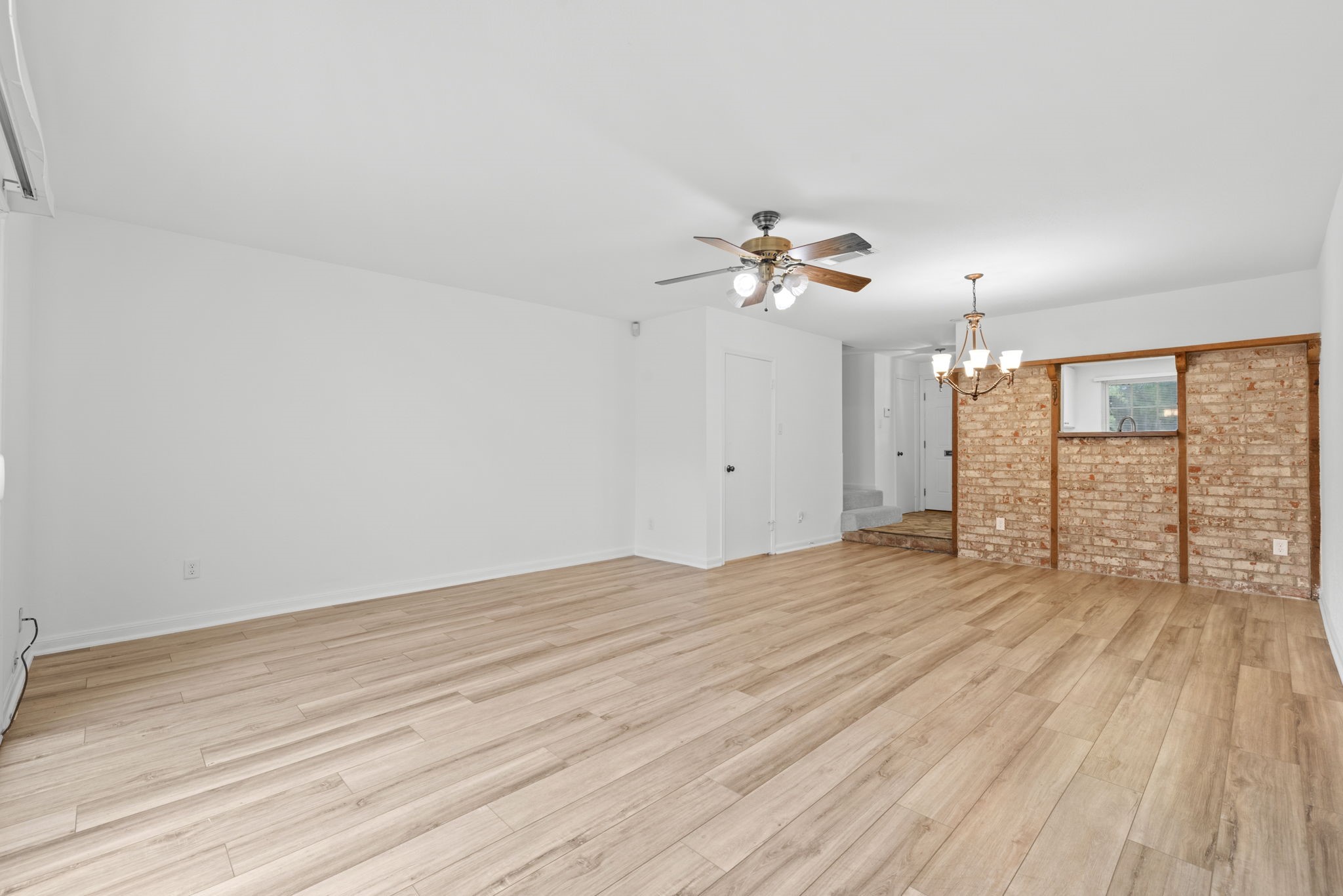 9668 Westview Drive, Unit 2 Houston, TX 77055 - Photo 14 of 34 wooden floor in an empty room with a window
