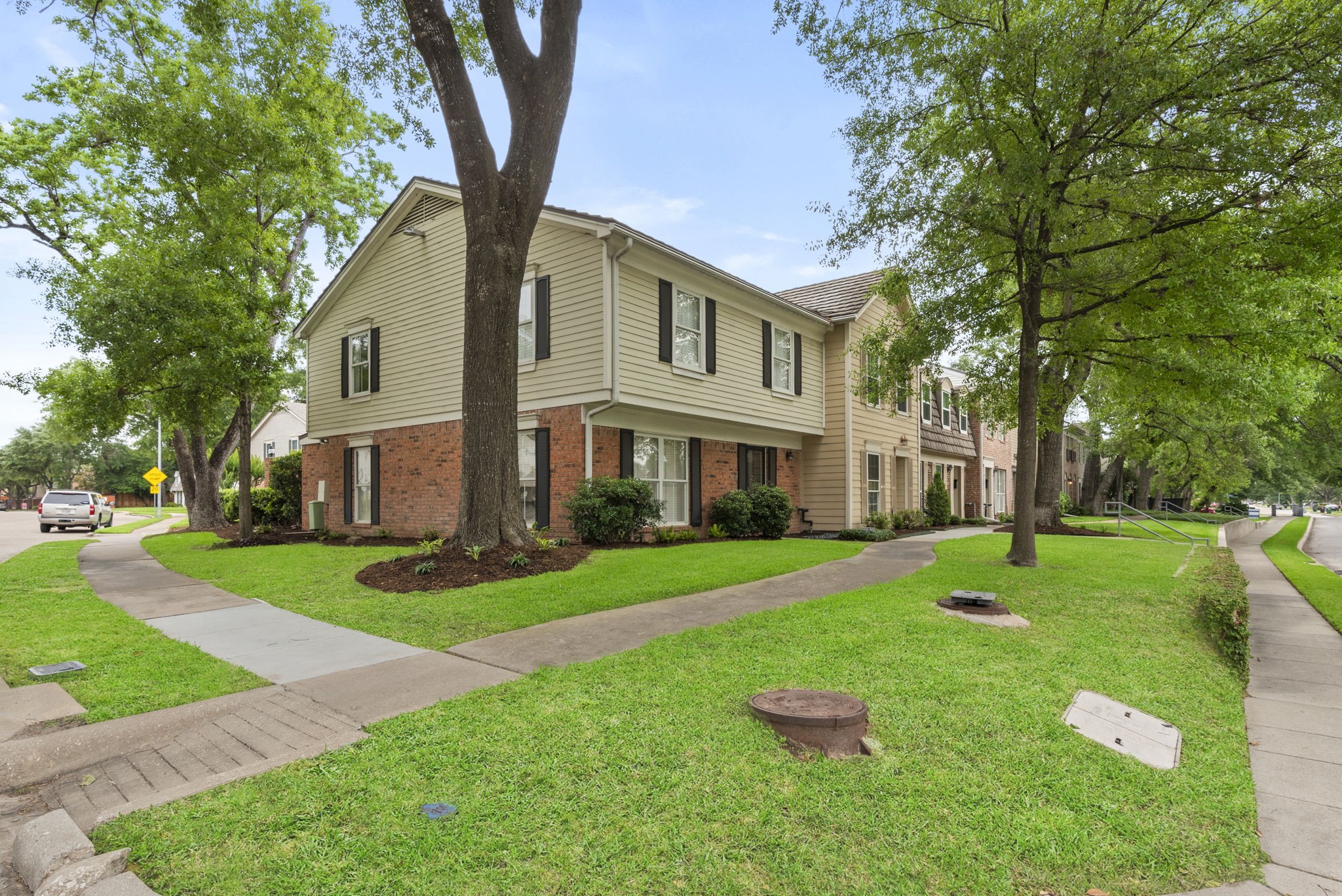 9668 Westview Drive, Unit 2 Houston, TX 77055 - Photo 4 of 34 a front view of a house with a yard and trees