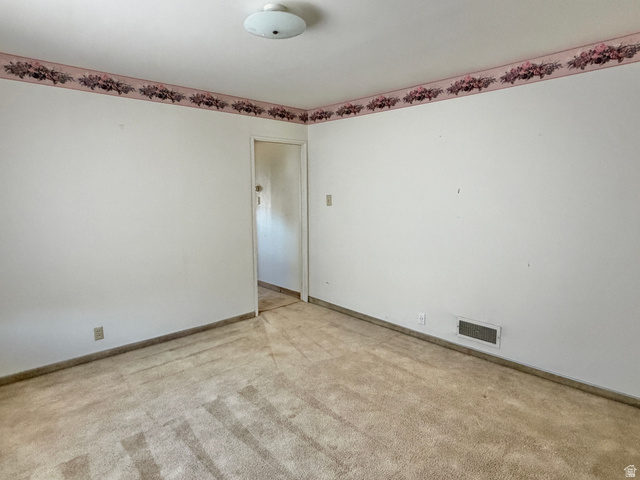 196 North 5th West Price, UT 84501 - Photo 10 of 27 Carpeted interior room with white walls, baseboards, and a floral wallpaper border