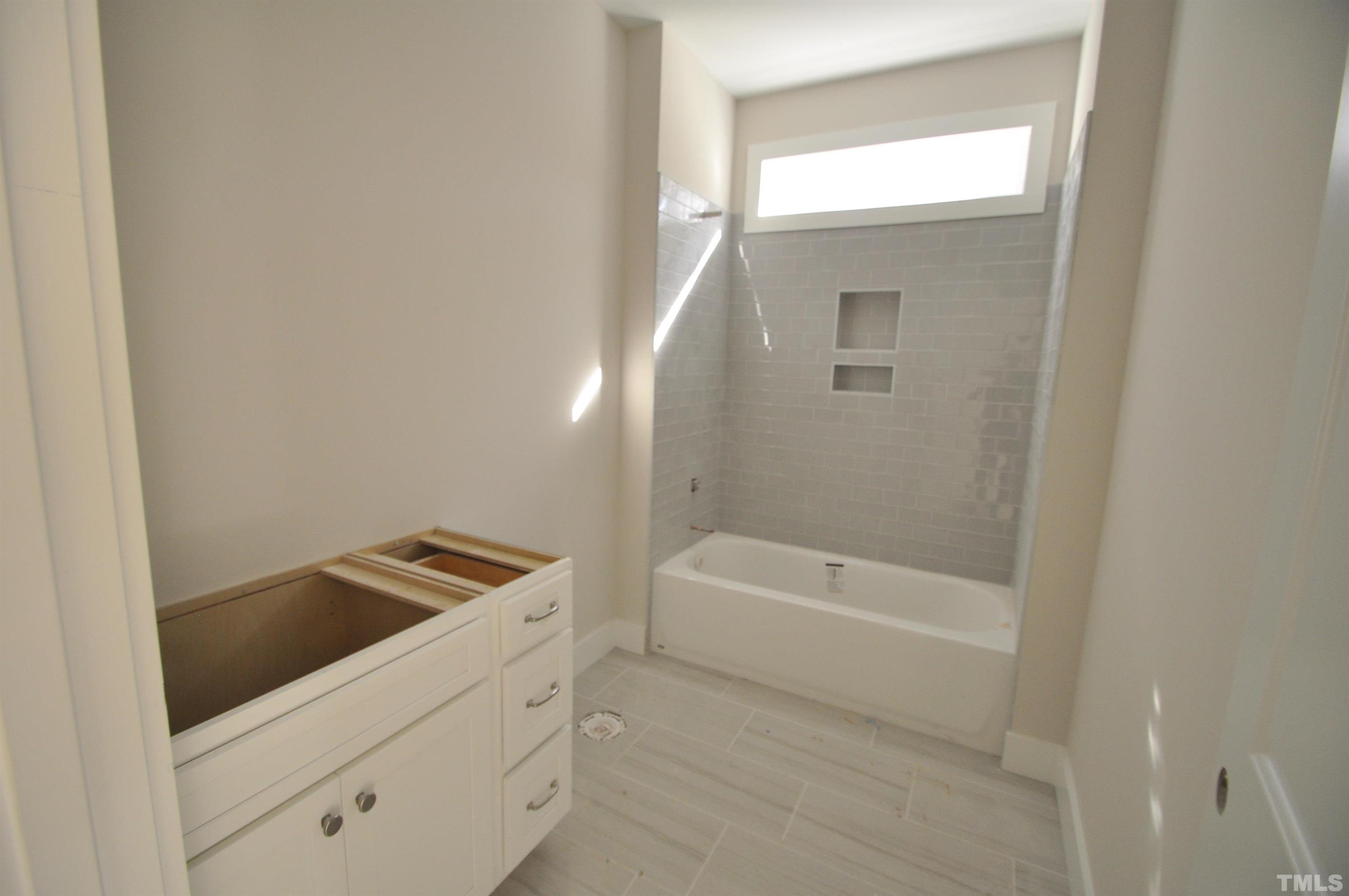 20 Pilot Ridge Road Zebulon, NC 27597 - Photo 9 of 14 a bathroom with a bathtub and a sink