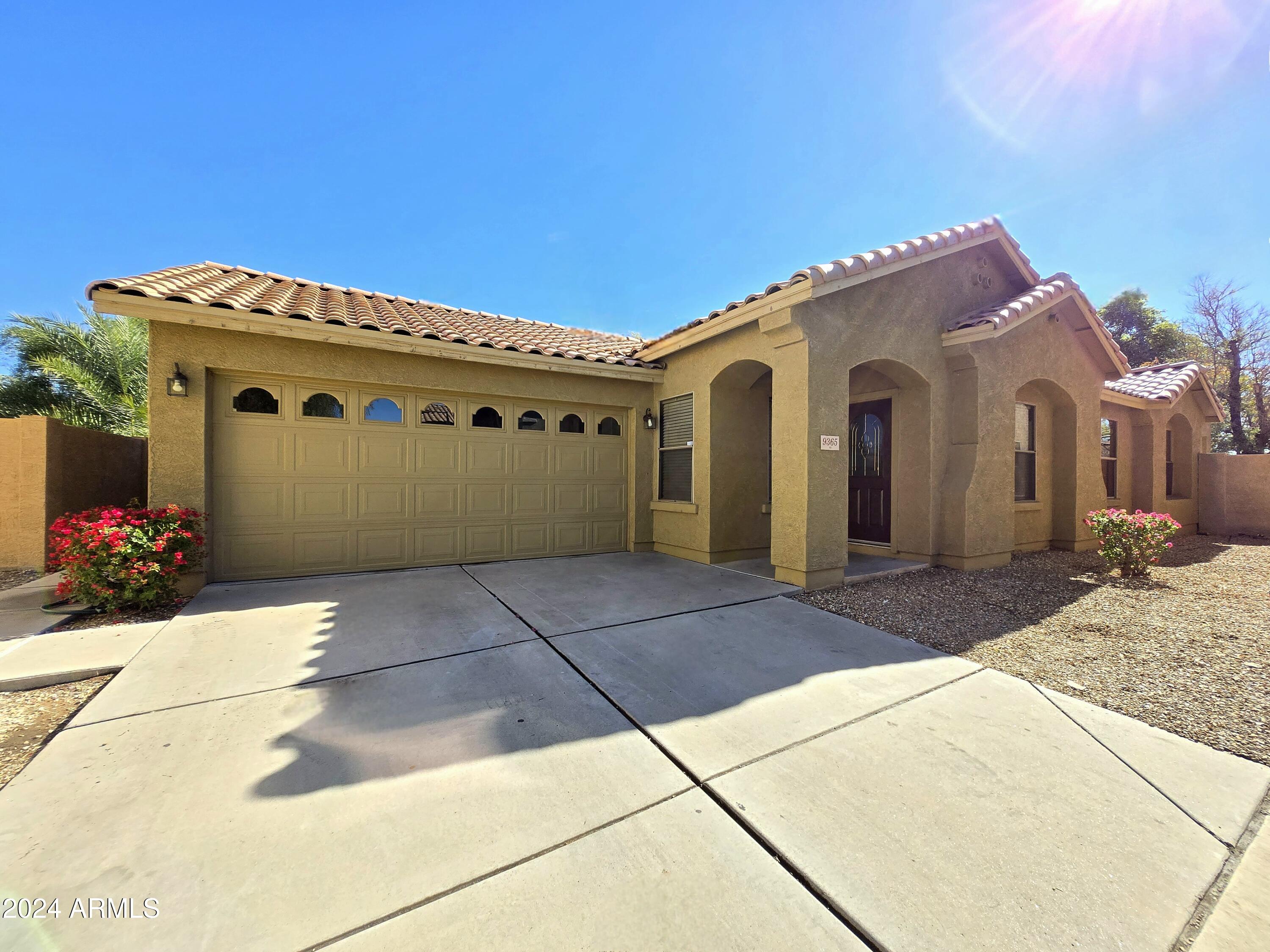 9365 West Eaton Road Phoenix, AZ 85037 - Photo 1 of 30 a front view of a house with a garage