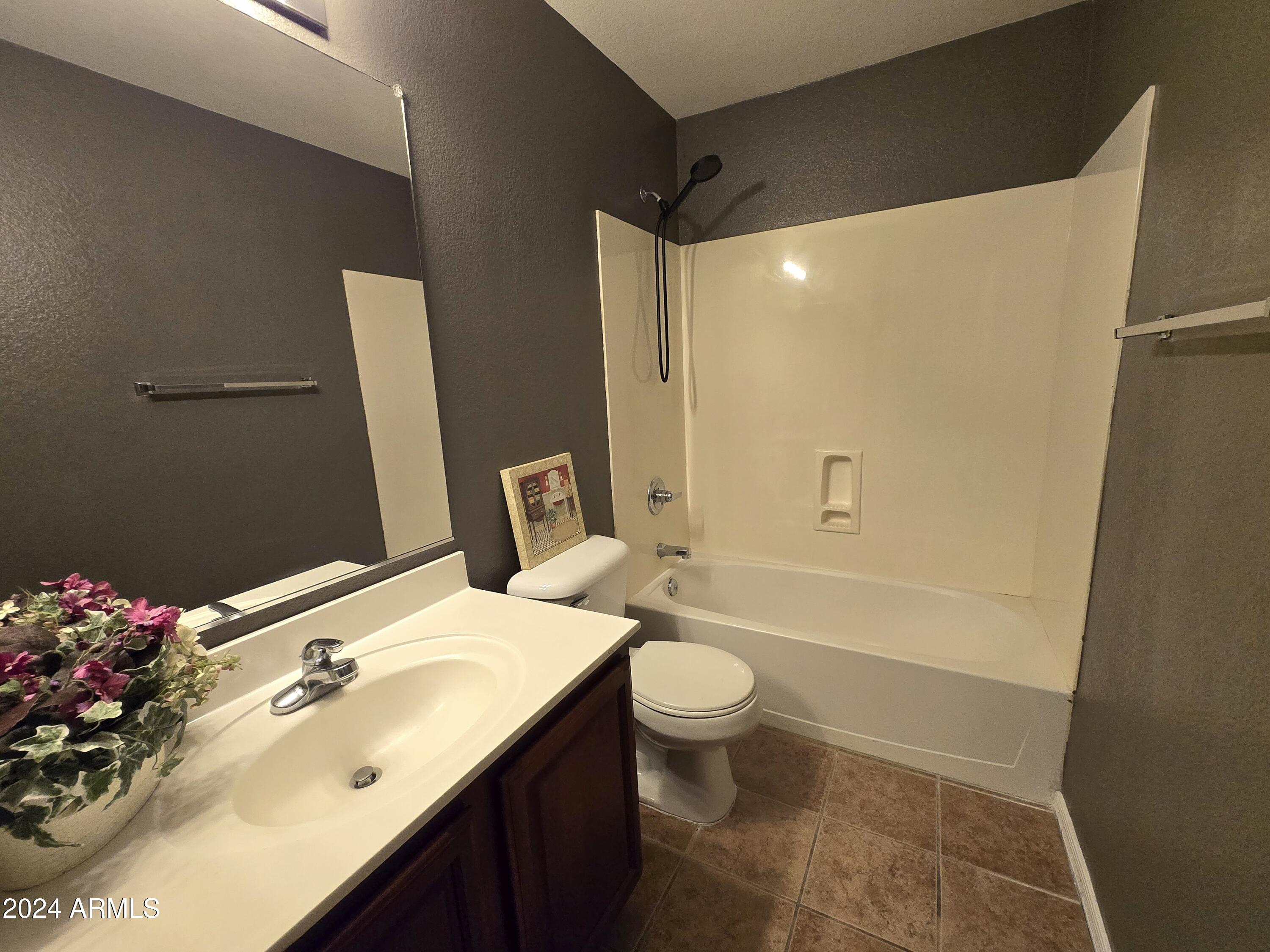 9365 West Eaton Road Phoenix, AZ 85037 - Photo 13 of 30 a bathroom with a sink toilet and shower